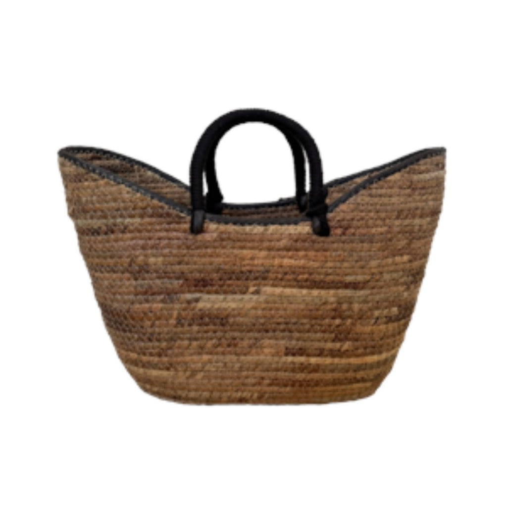 Woven basket with black handles on a white background