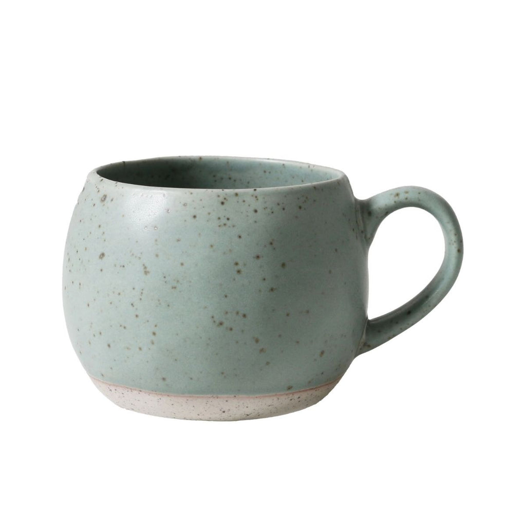 Speckled green mug on a white background