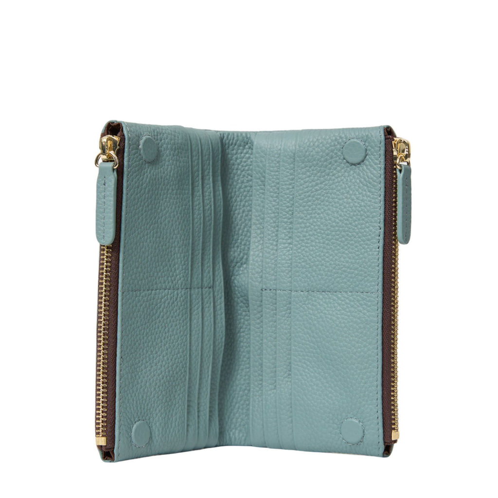 inside of a blue wallet featuring zips on sides and card slots