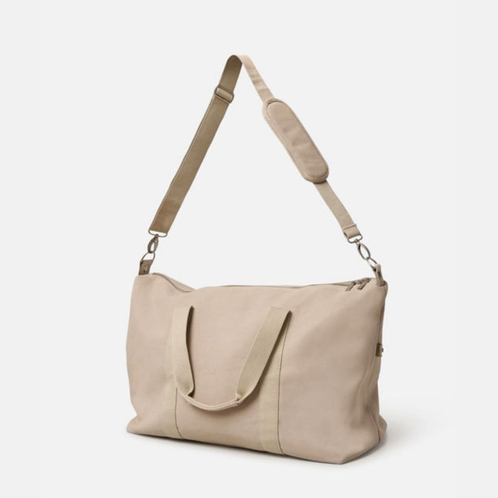 Beige shoulder bag with a strap on a white background