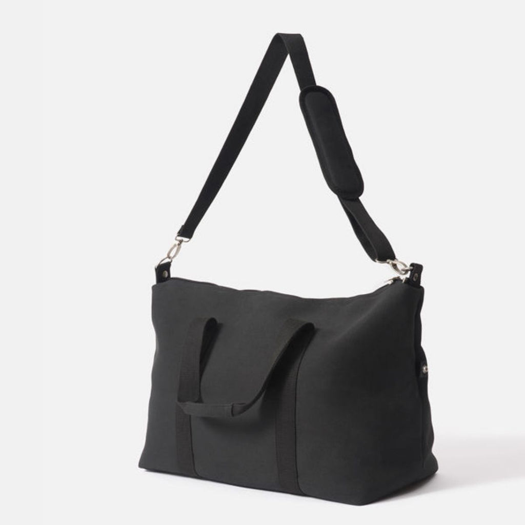 Black shoulder bag with a strap on a white background