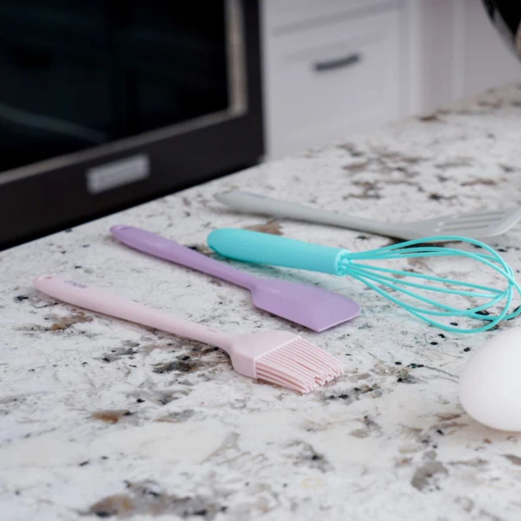 Colorful silicone utensils on a marble countertop