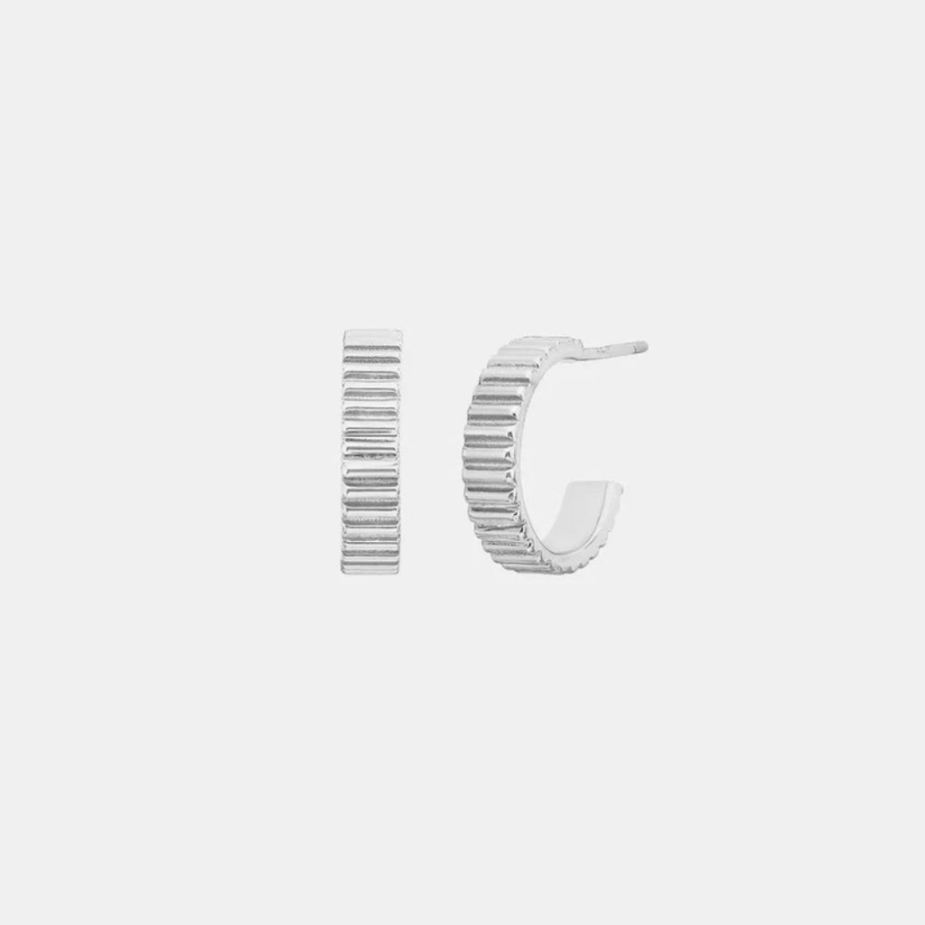 Silver hoop earrings on a light gray background