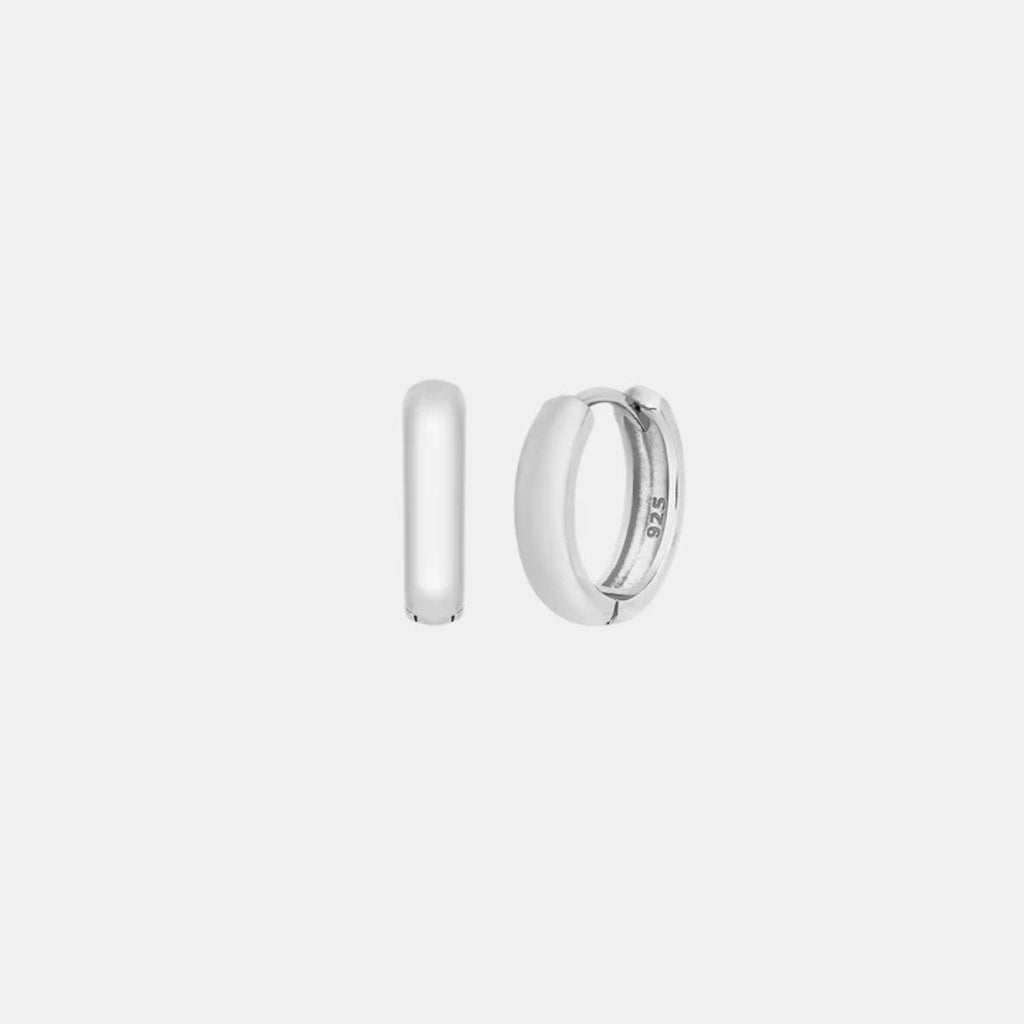 Pair of silver hoop earrings on a light gray background