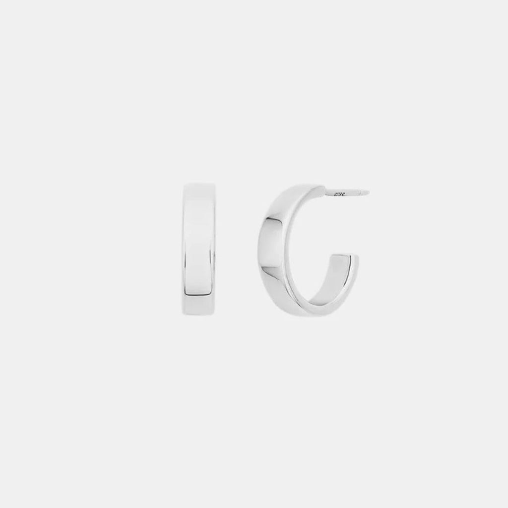 Silver hoop earrings on a light gray background