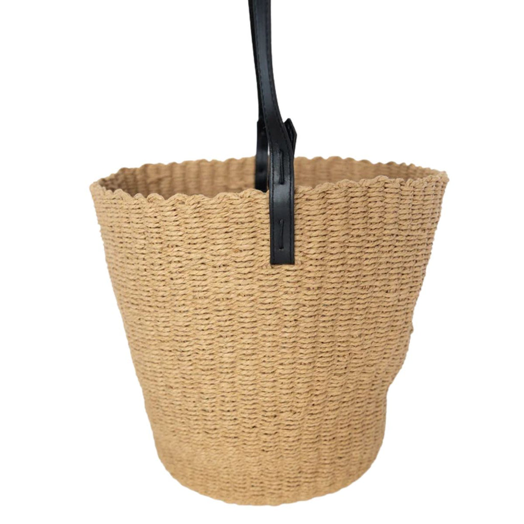 Beige woven basket with a black handle on a white background