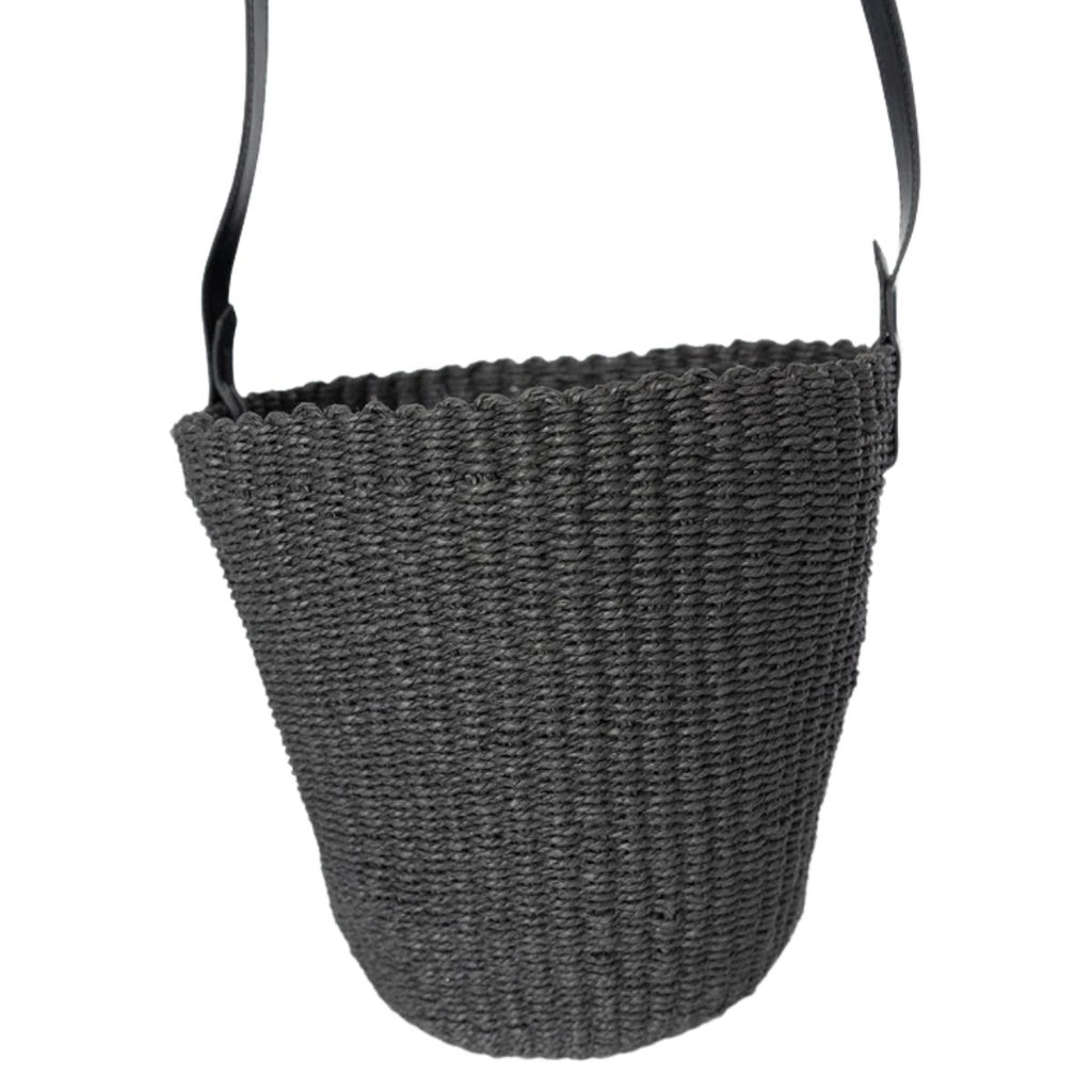 Black woven basket with a handle on a white background