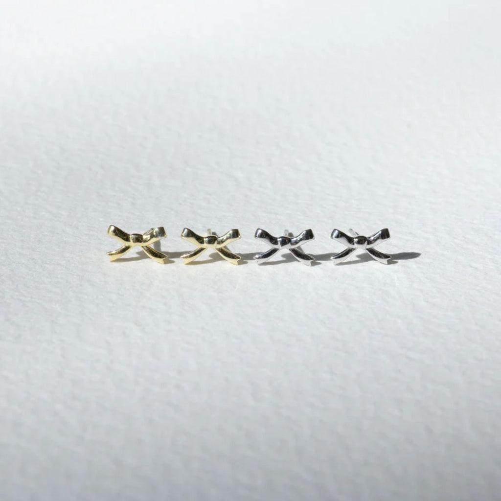 Set of four gold and silver hair clips on a white background