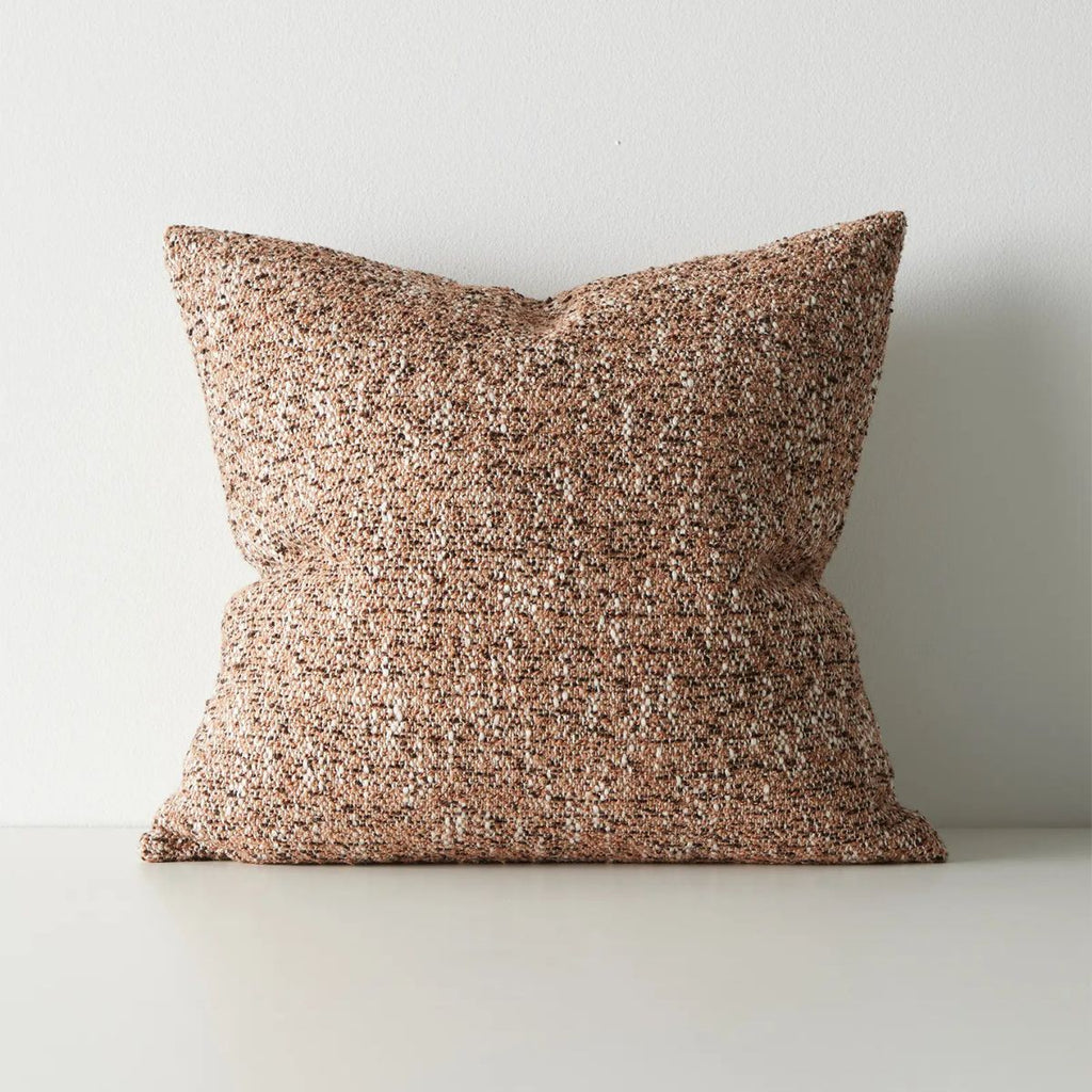 Textured brown pillow on a light gray background