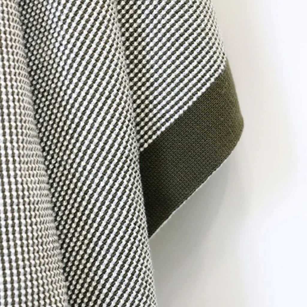 close up texture of a green olive patterned blanket
