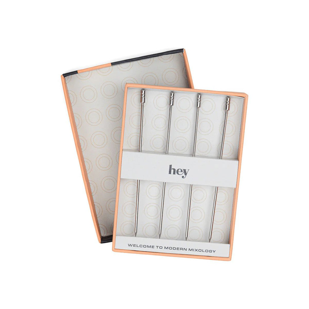 Packaging of cocktail picks with 'hey' branding on a white background