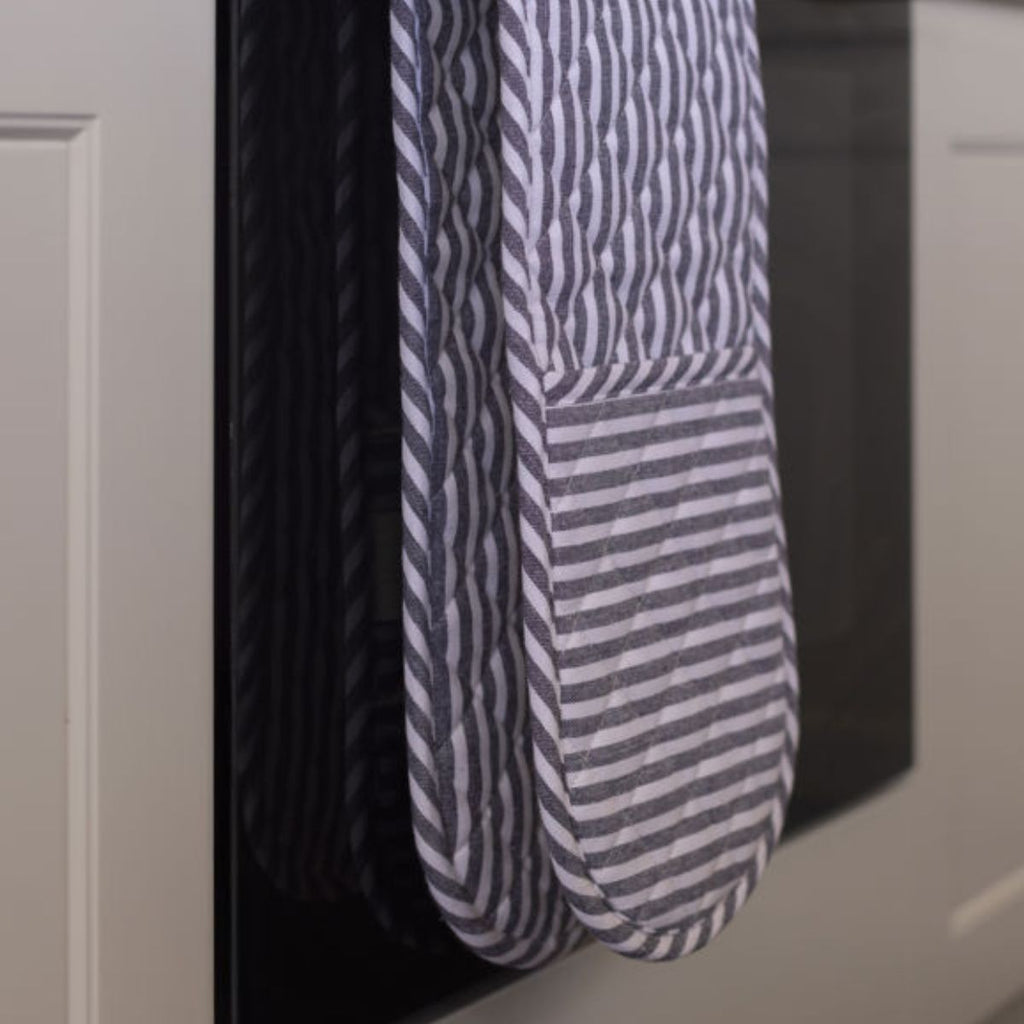 Blue and white striped oven mit hanging in a kitchen