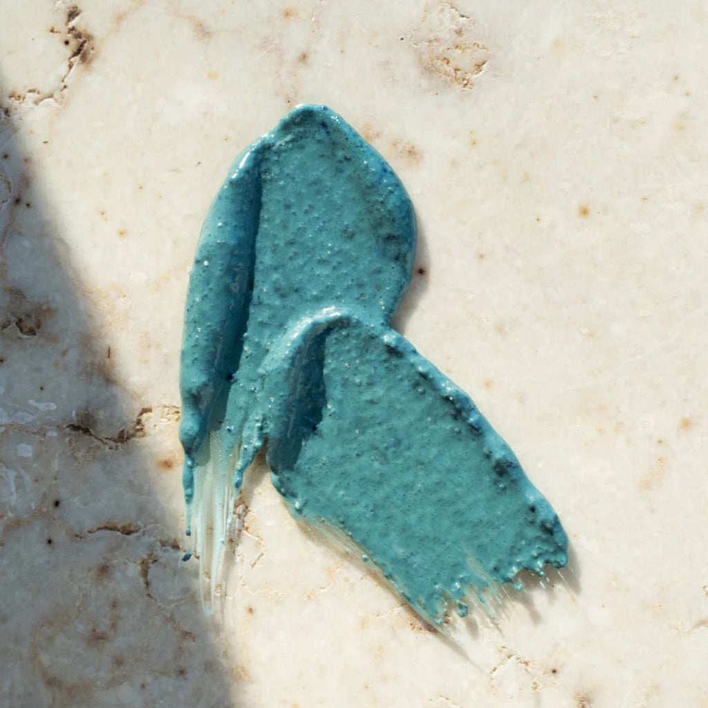 Blue smear of cream on a beige surface