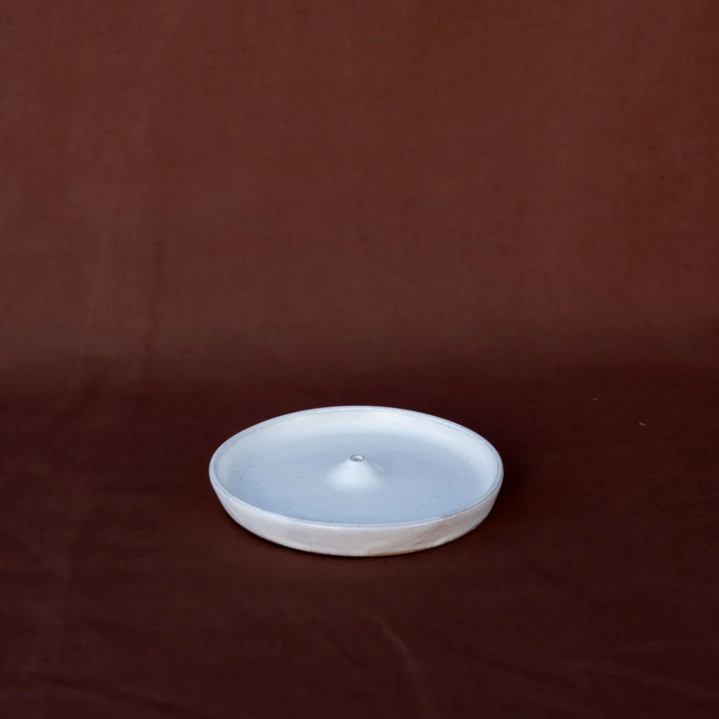 Ceramic plate with a textured surface on a brown background