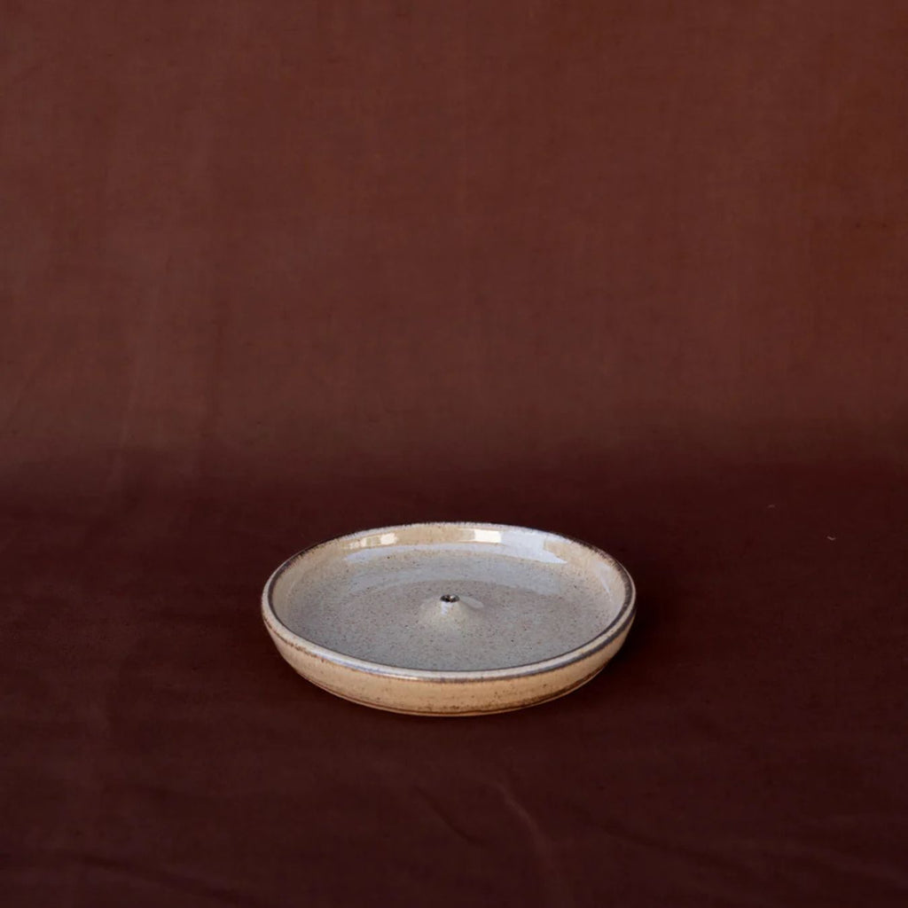 Ceramic plate with a textured surface on a brown background