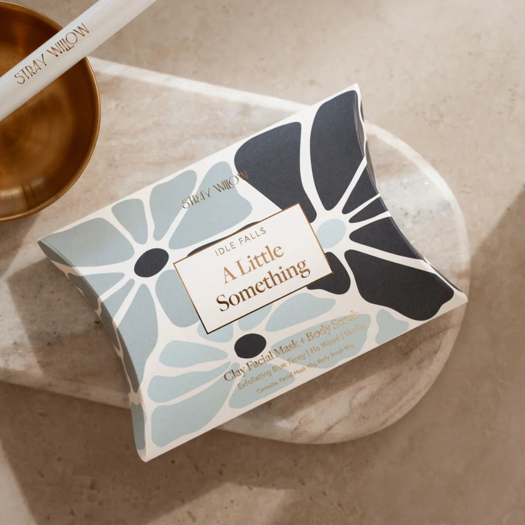 Facial mask with floral design packaging on a marble surface