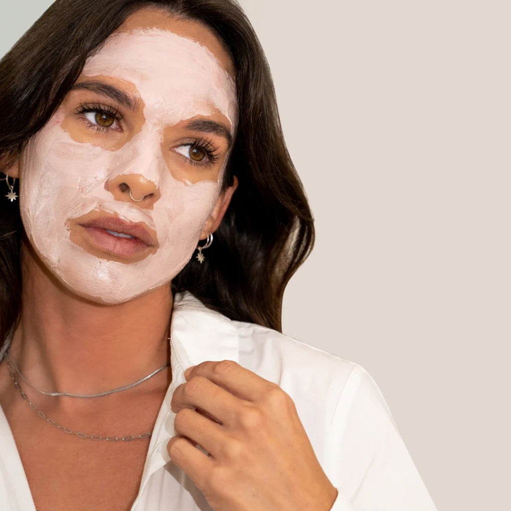 Woman wearing a face mask with a neutral background