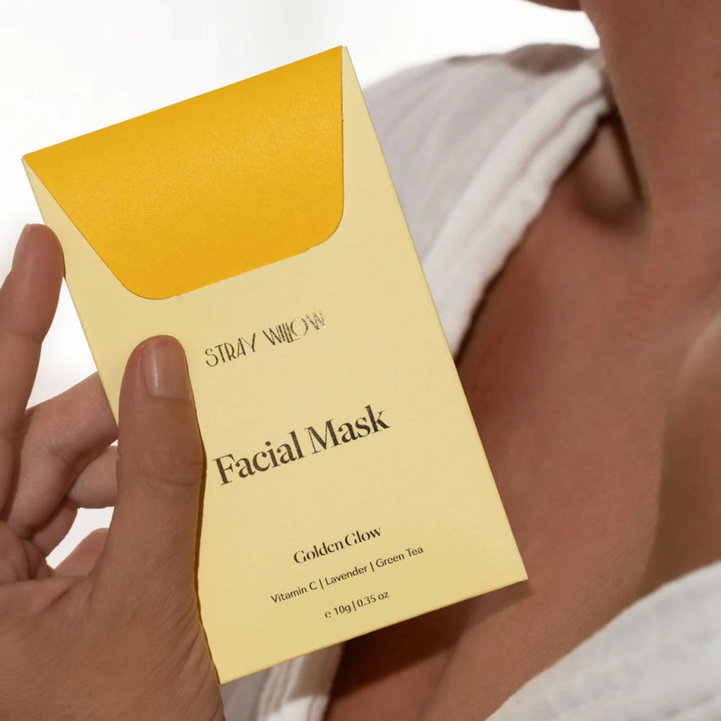 Stray Willow Golden Glow facial mask packaging held by a hand