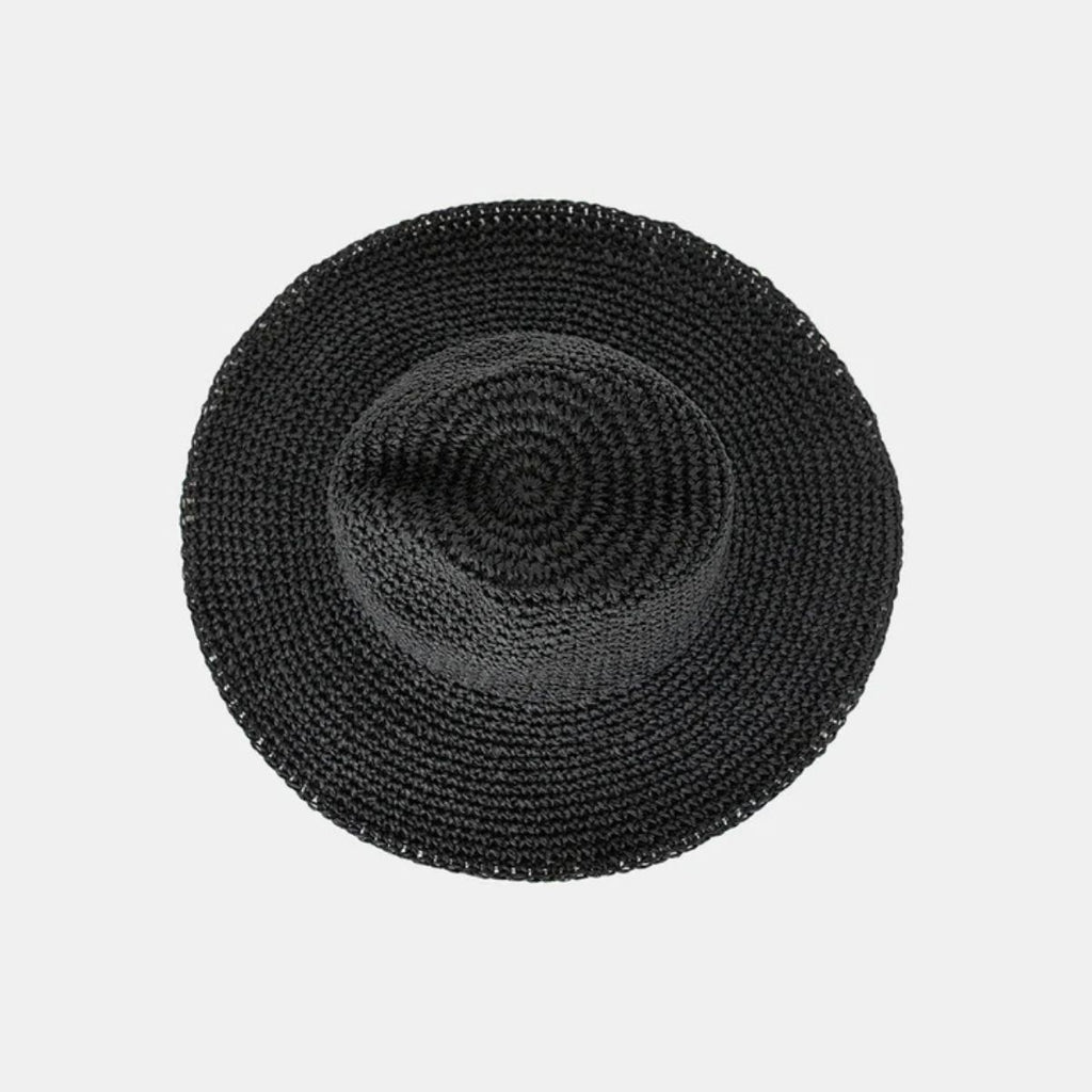 Black woven round placemat on a light gray background