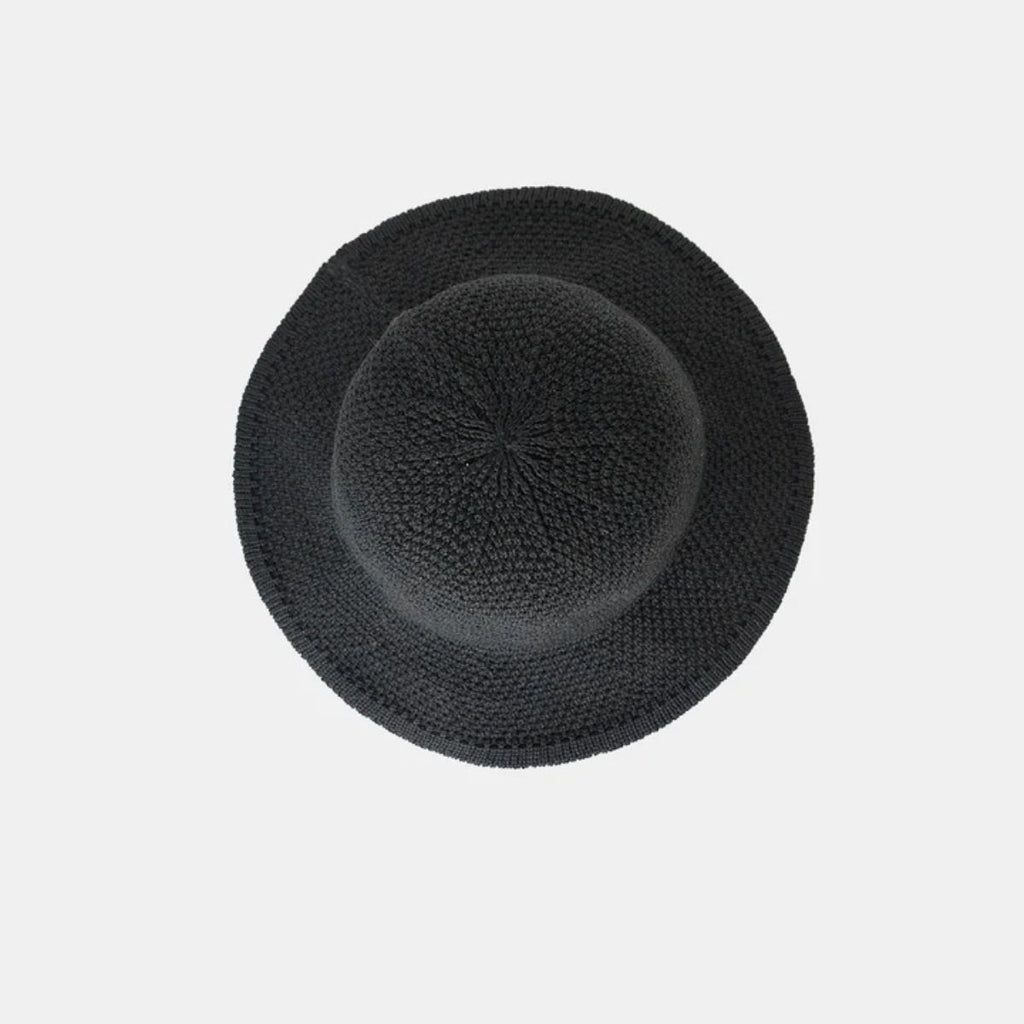 Black knit hat on a light gray background
