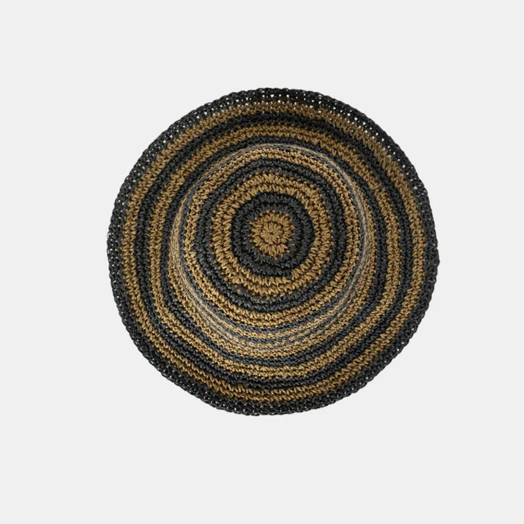 Round woven mat with concentric circle pattern on a light gray background