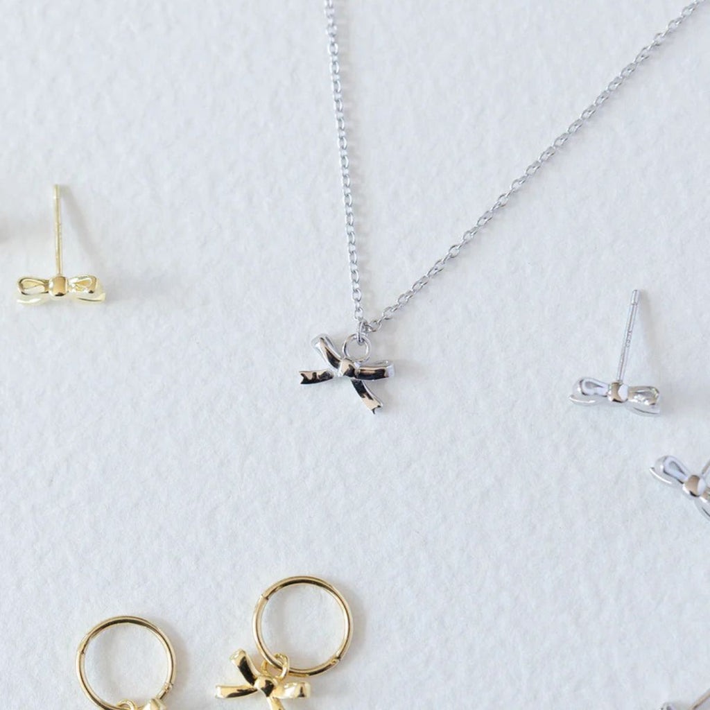 Jewelry set including earrings and a necklace on a white background