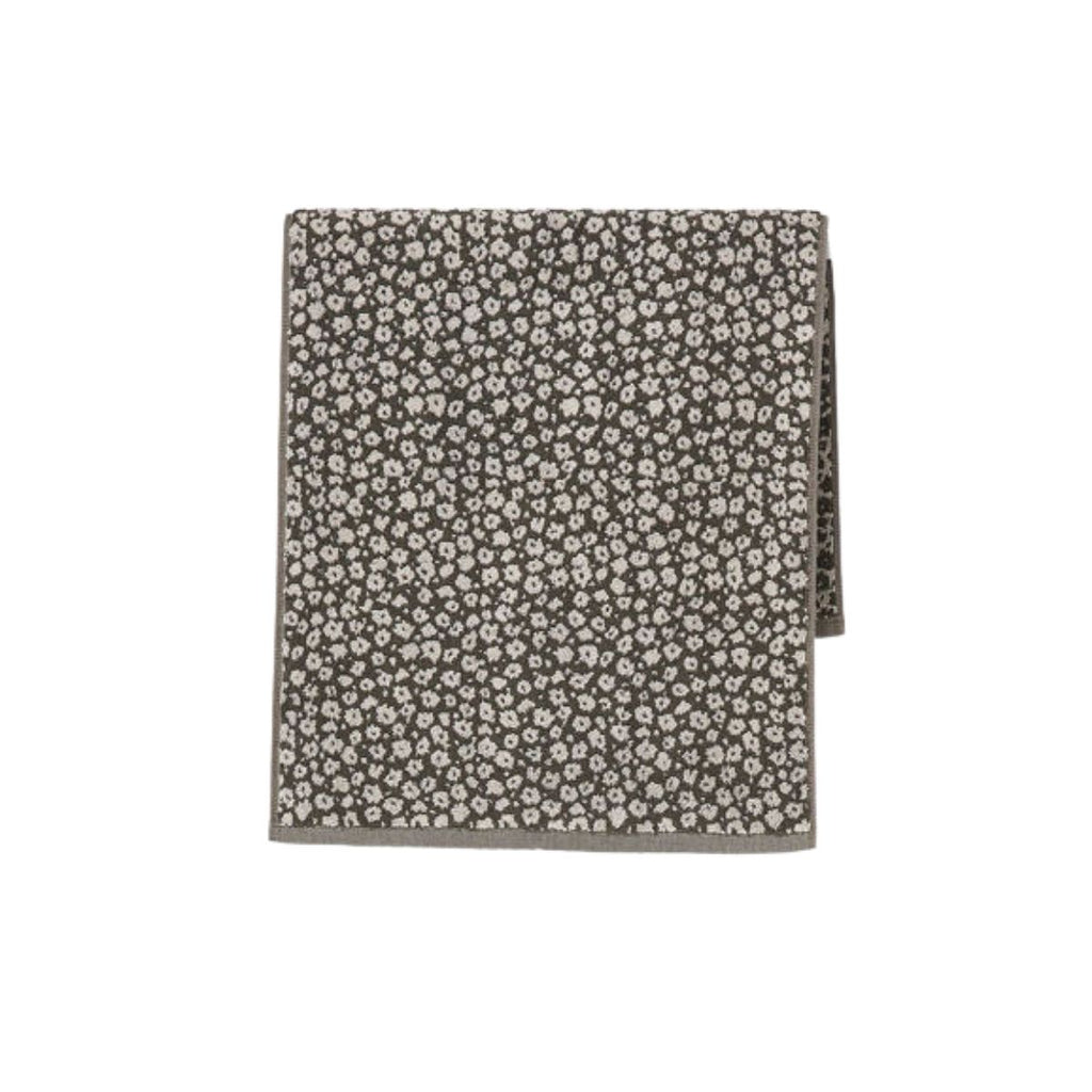 Floral patterned fabric bath mat on a white background