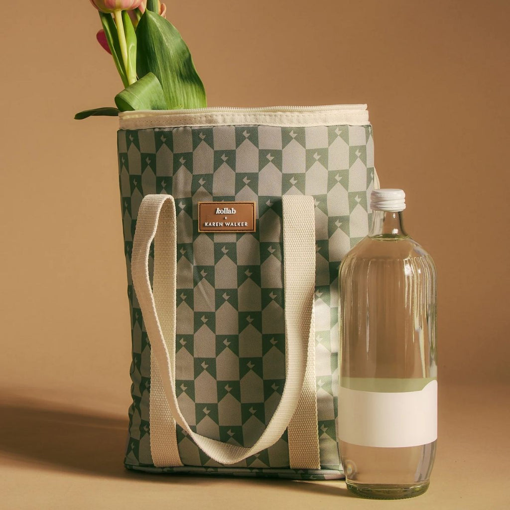Patterned tote bag with a bottle of water on a beige background
