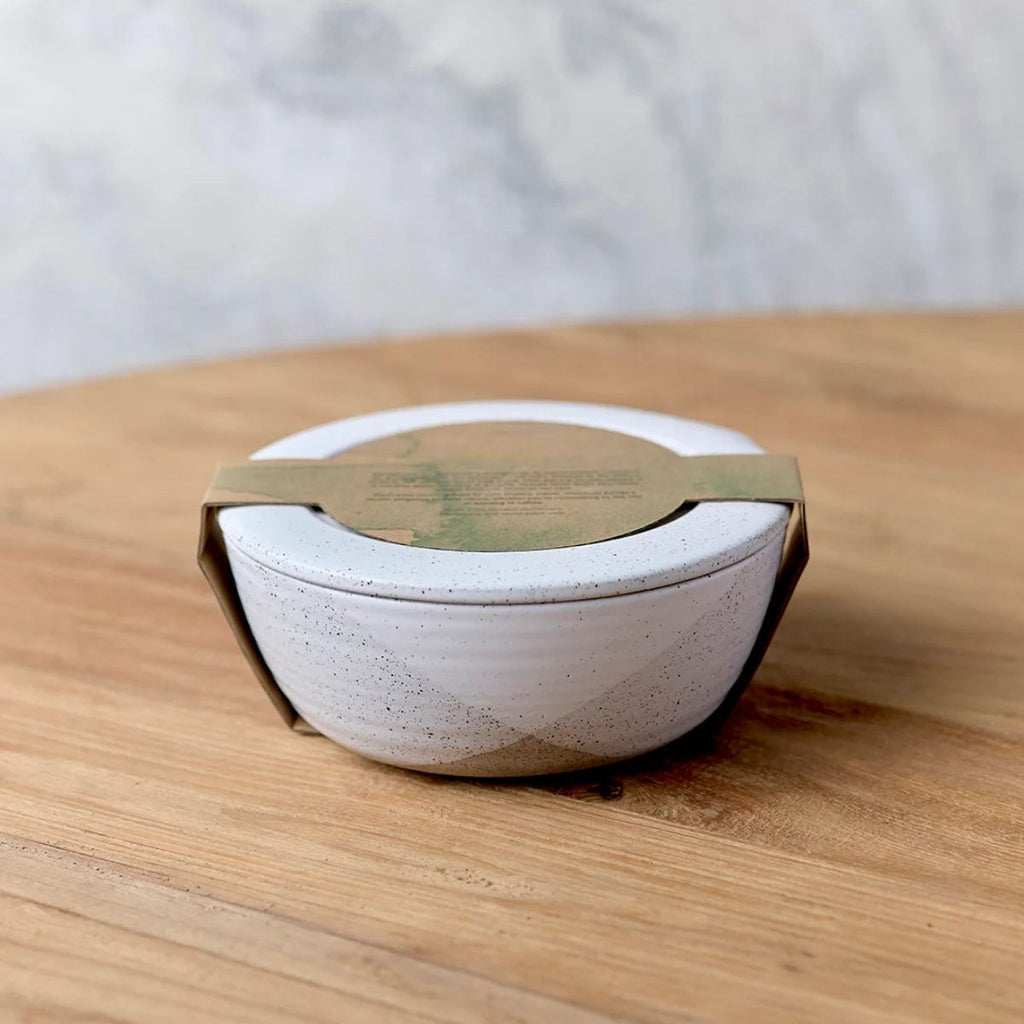 Ceramic container with a lid on a wooden surface