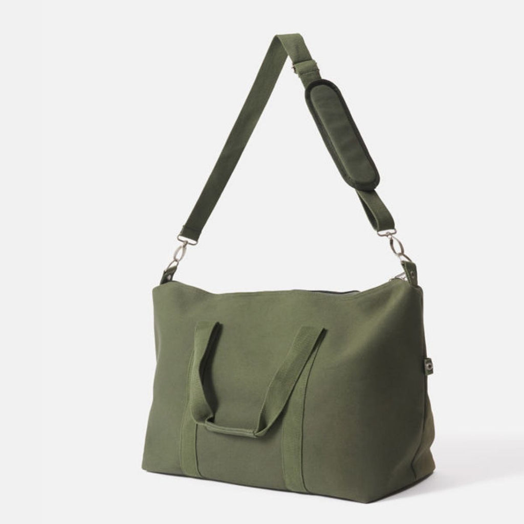 Green shoulder bag with a strap on a white background