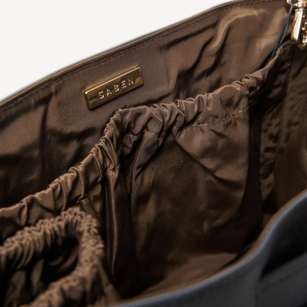 Brown handbag with 'SABEN' brand name on a white background