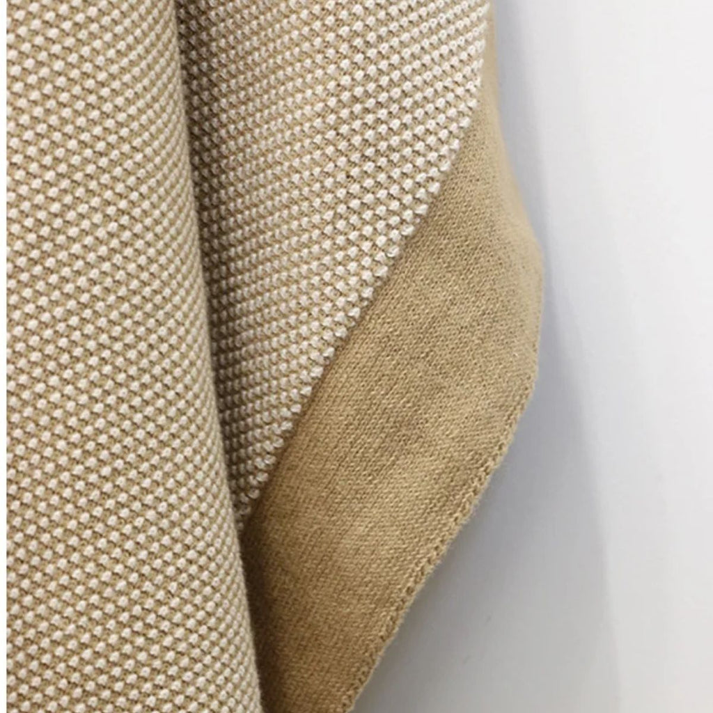 Close-up of a beige textured fabric on a white background