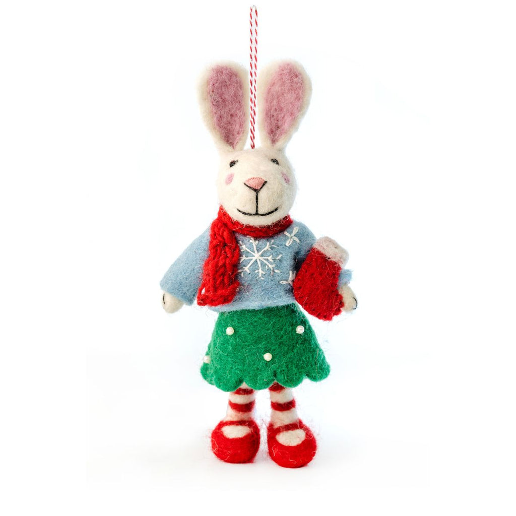 Decorative rabbit ornament wearing a sweater, scarf, and shoes on a white background