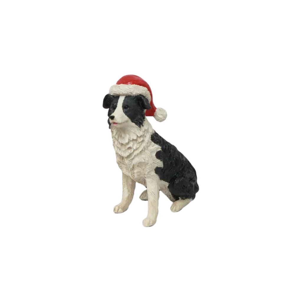 Dog figurine wearing a Santa hat on a white background