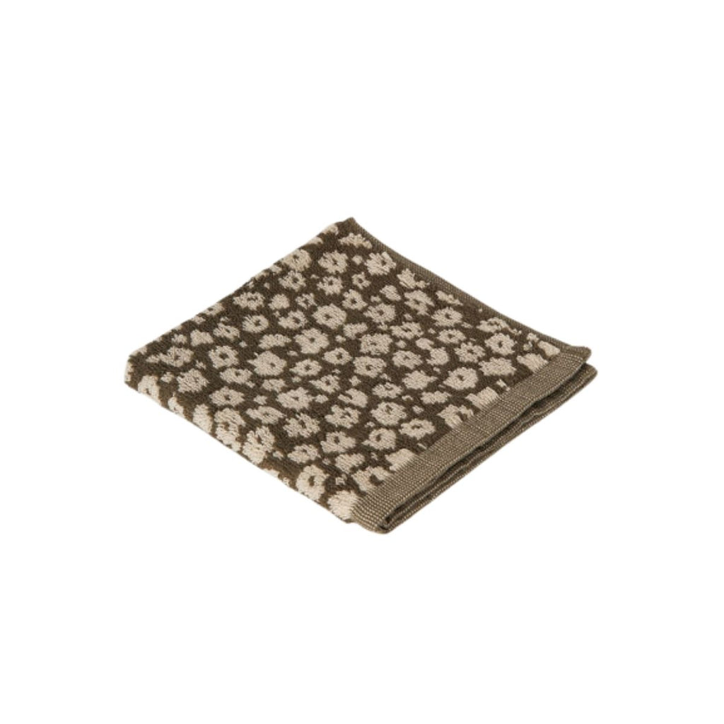 Folded face cloth white floral pattern on a white background