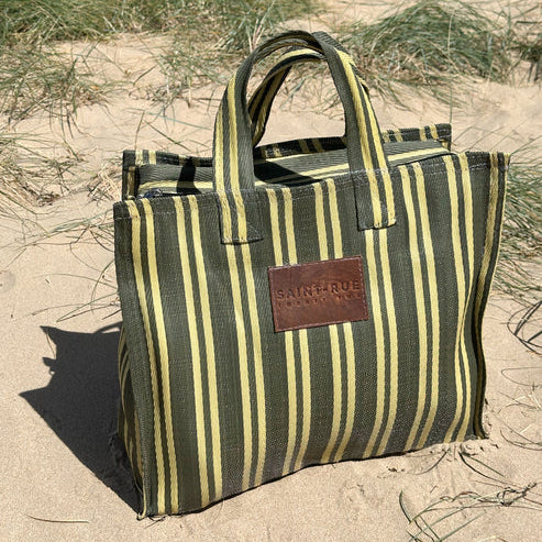 Striped tote bag on a sandy background