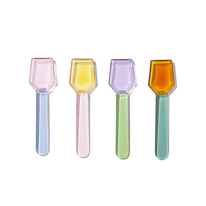 Four colorful plastic ice cream scoops on a white background
