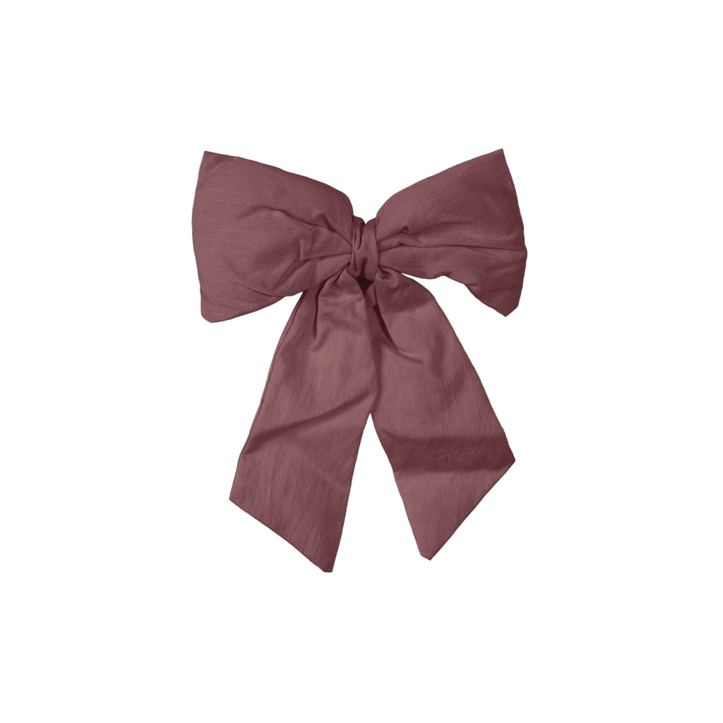 Large pink bow on a light gray background