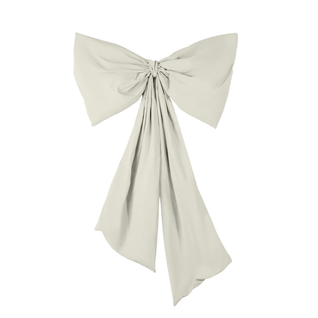Beige bow-shaped fabric accessory on a light gray background
