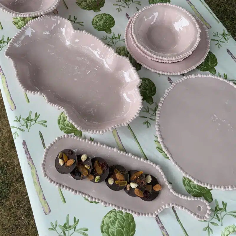 Set of melamine dishes on a table with a floral pattern
