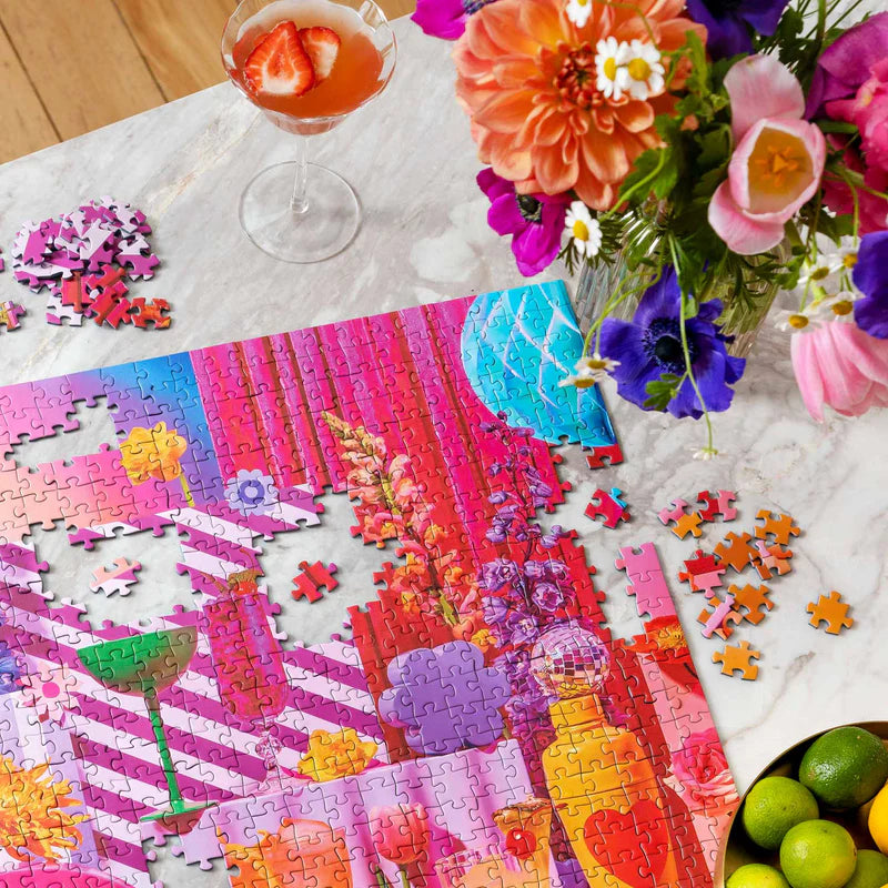 Colorful puzzle on a table with flowers and a drink