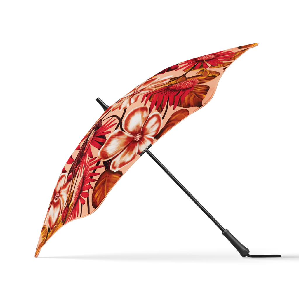 A pink, brown and white floral print and black handle blunt brand umbrella