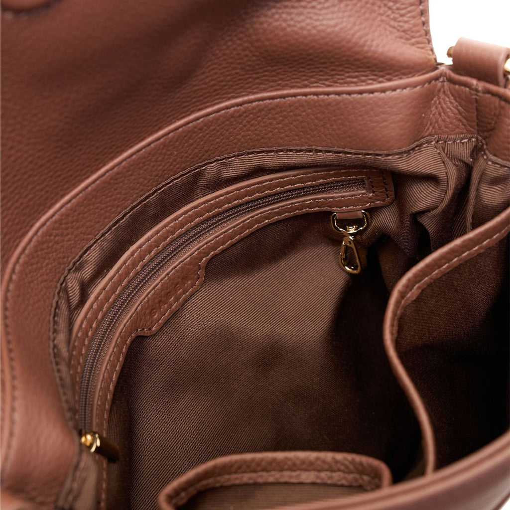 Close-up of a brown leather bag with a zipper