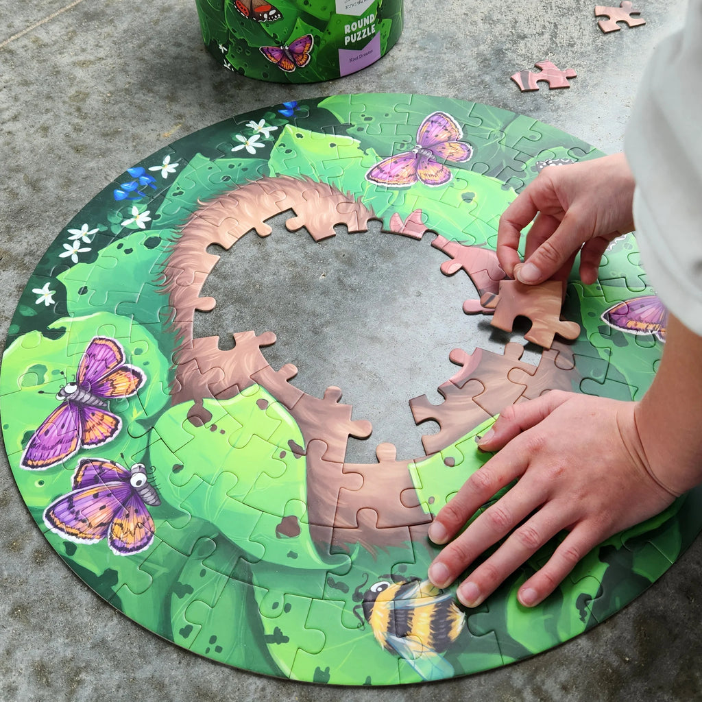 Round puzzle with butterfly design on a concrete surface