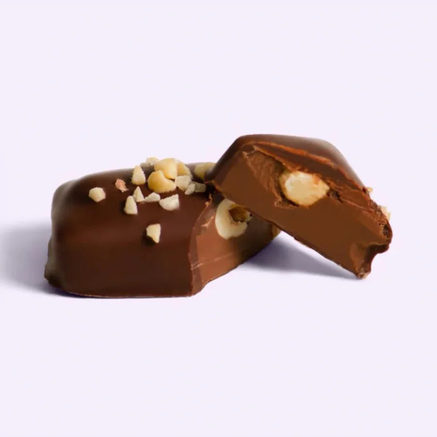 Chocolate-covered candy with nuts on a white background