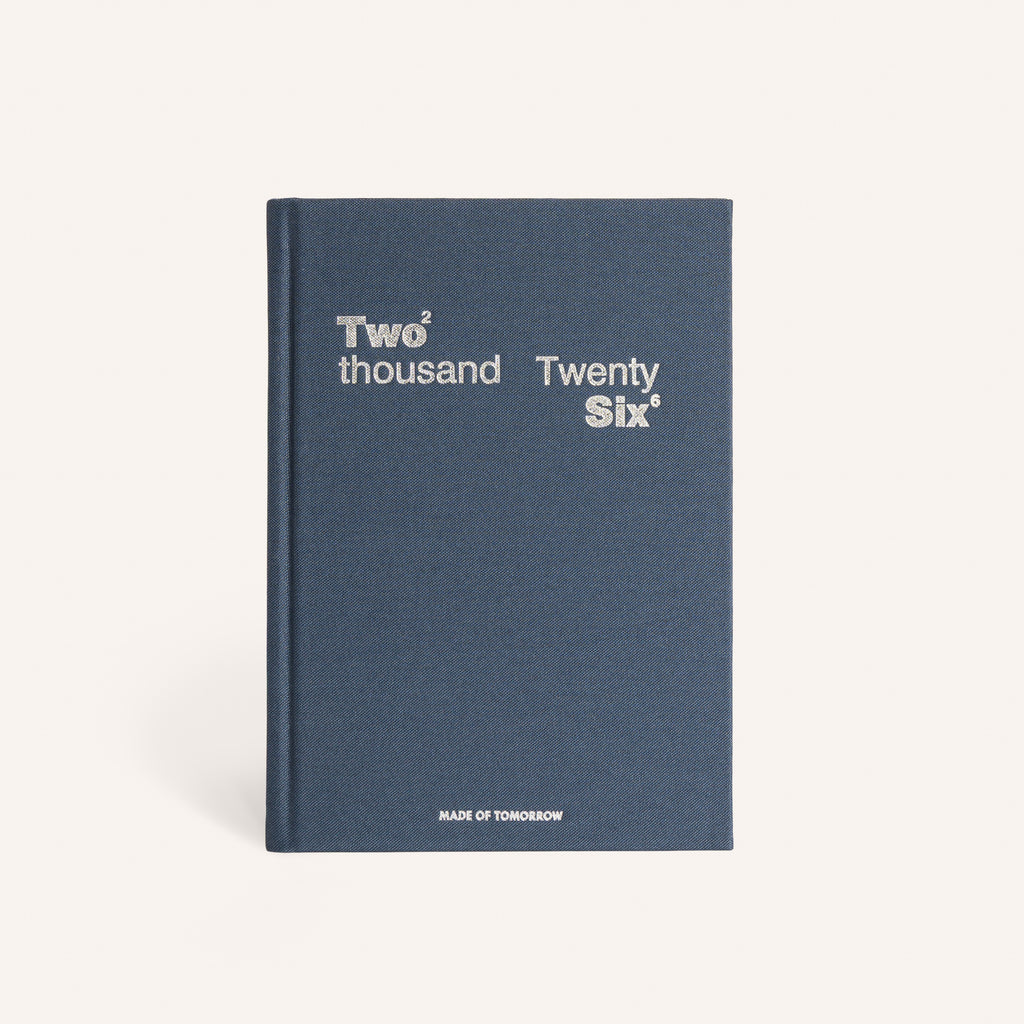 Blue notebook with 'Two thousand Twenty Six' text on a white background