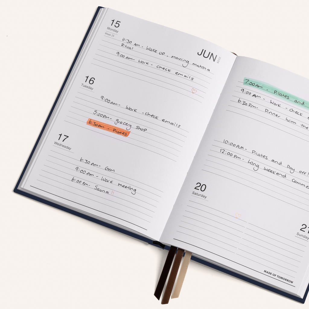 Open daily planner with handwritten tasks and appointments on a white background