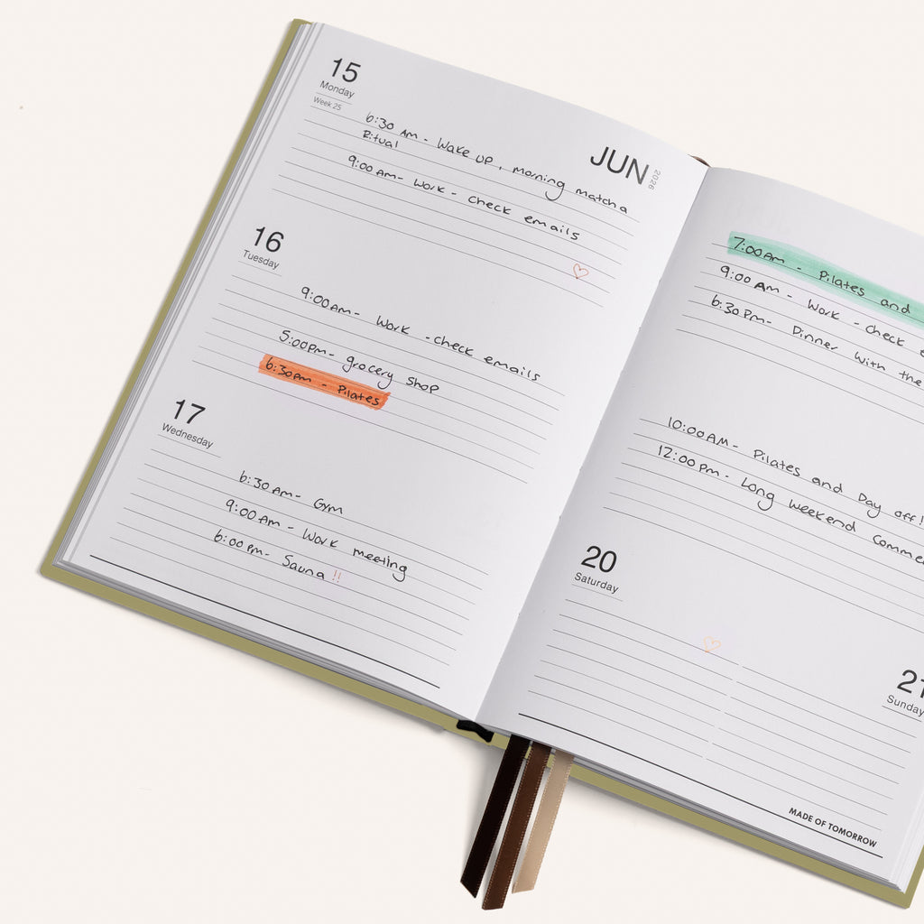Open daily planner with handwritten tasks and appointments on a white background