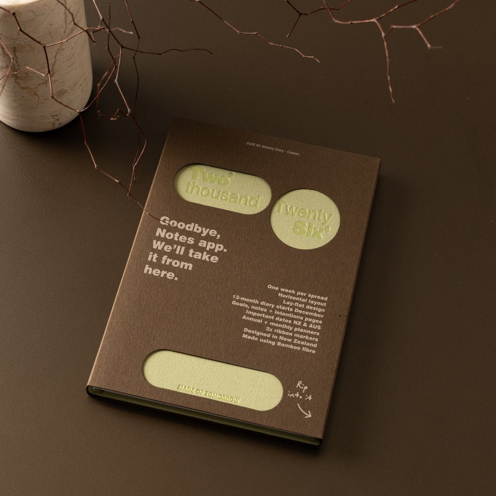 Brown notebook with text on a dark surface