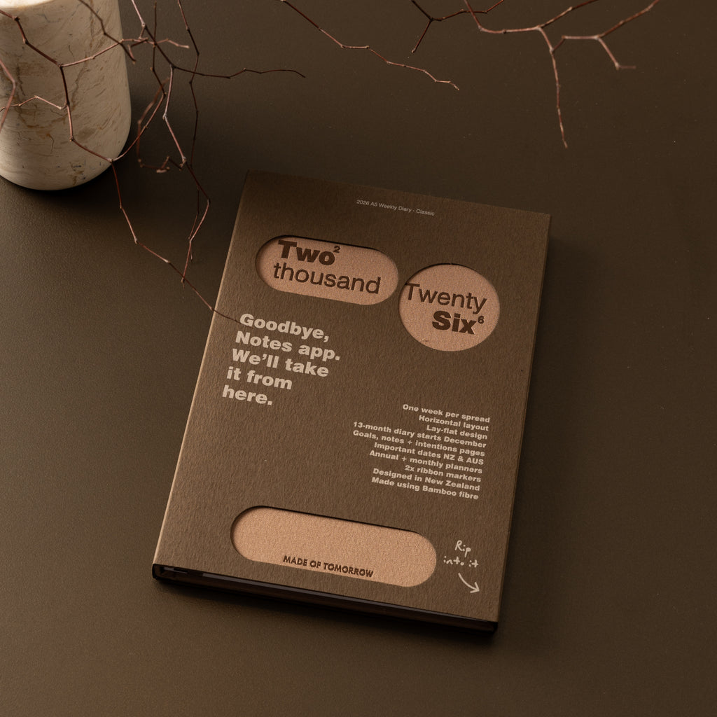 Brown notebook with text on a dark surface
